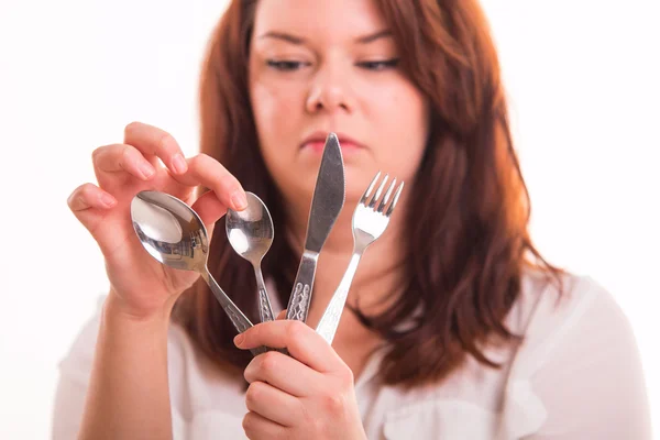 Housewife holding cutlery set — Stock Photo, Image