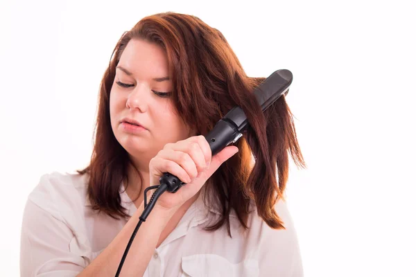 Woman trying to straighten hair — Stock Photo, Image