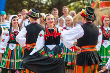 Traditional colorful folk dance group from Lowicz, Poland  clipart