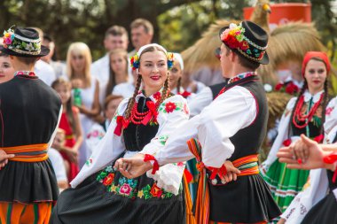 Traditional colorful folk dance group from Lowicz, Poland  clipart