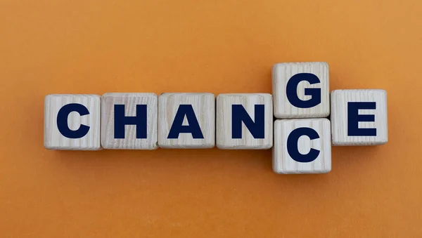 CHANGE to CHANCE - word on wooden cubes on a beautiful yellow background. Personal development and career growth.