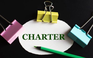 CHARTER - beyaz kağıt üzerinde kelime çok renkli ataç ve yeşil kalem ile. İş konsepti