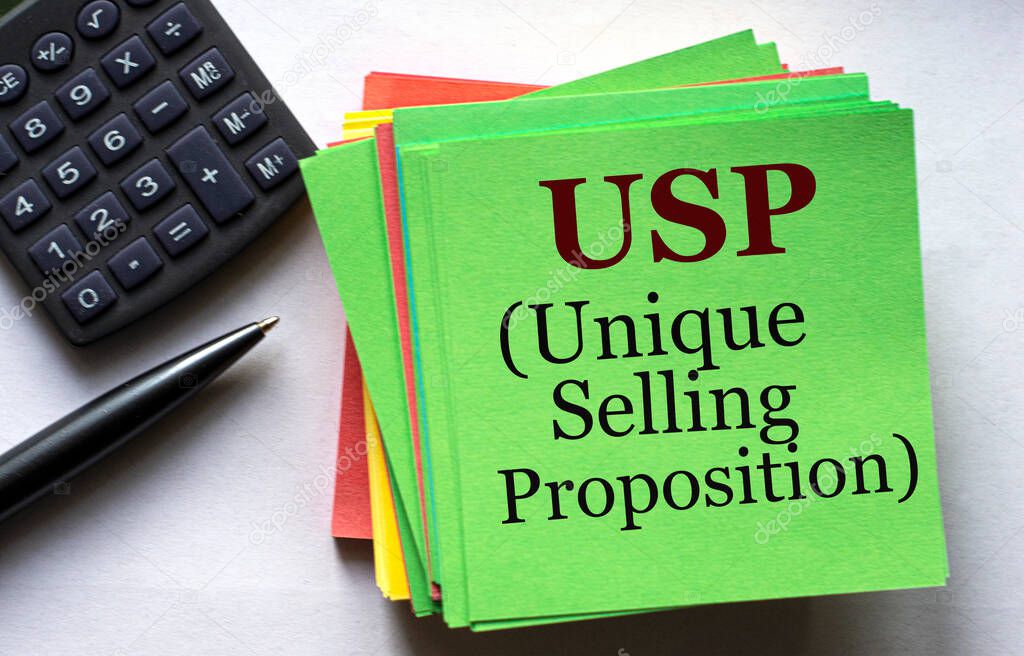 USP (Unique Selling Proposition) - text on a green note sheet against the background of a calculator and a pen. Business and finance concept.