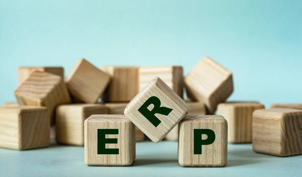 ERP ( Enterprise Resource Planning) - acronym on wooden cubes on a light background. Business concept