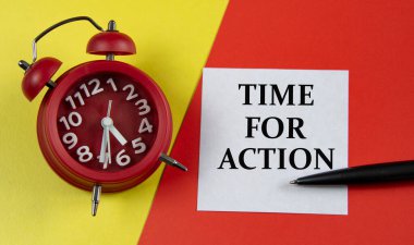 TIME FOR ACTION - words on a white sheet on a multi-colored background with an alarm clock and a pen. Business concept