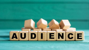 AUDIENCE - word on wooden cubes on a green background with lavender. Business concept