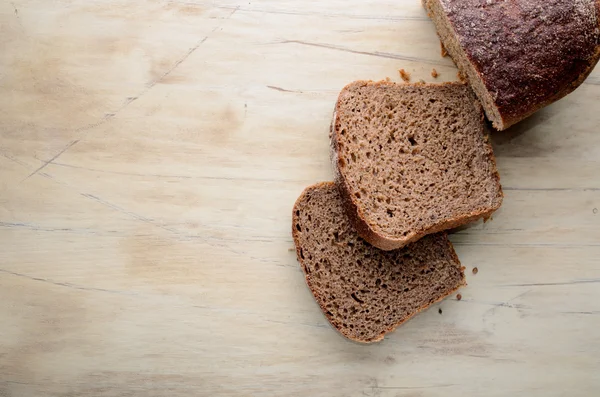 Two slices of bread on a wooden table — Stock Photo, Image