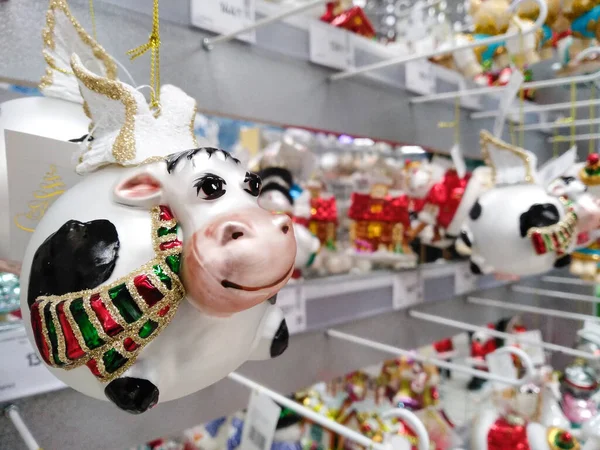 stock image Lutsk/Ukraine - November 26 2020. Christmas tree toy symbol of 2021 White Metal Bull. Rack with Christmas tree decorations in the Epicenter shopping center.