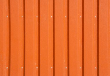 Turuncu metal çit arka planı. Çitli tahtadan. Terracotta arka planı. Çinko metal yaprak dokusu. Duvarın çelik paneli..