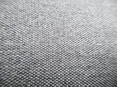 Fotokopi alanı olan yakın plan gri kumaş dokusu. Mobilyalar için makro gri döşeme. Gri desenli kumaşın seçici odağı. Duvar kağıdı ve arka plan. İç kısım için kalın gri malzeme..