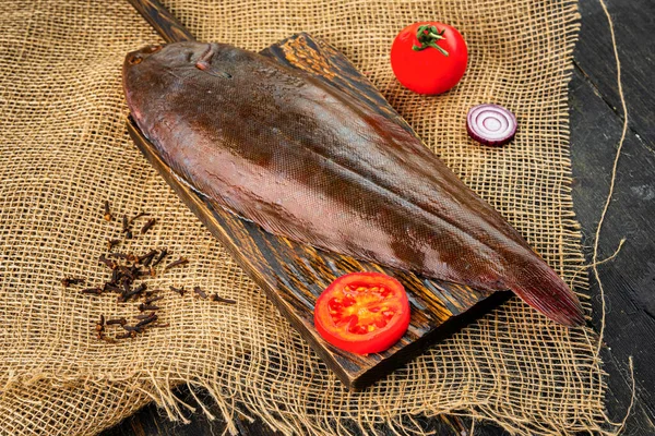 Raw fresh sole fish on a cutting board