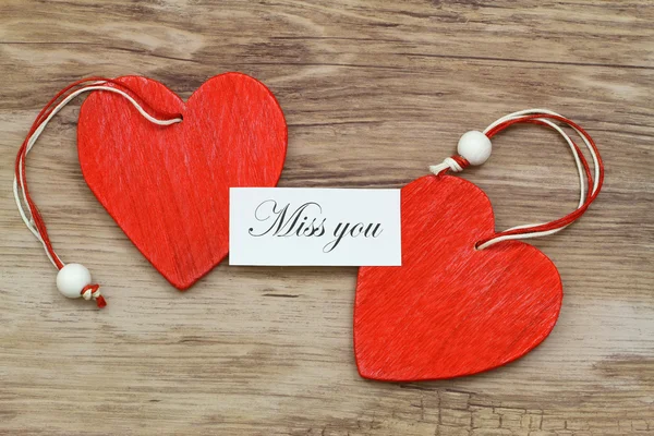 Miss you card with two red wooden hearts — Stock Photo, Image