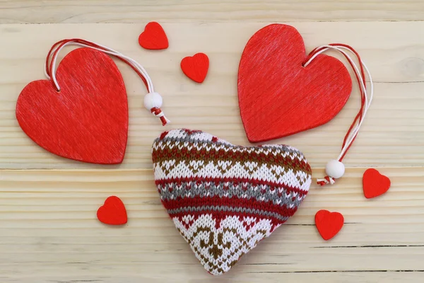 Wooden and knitted hearts  on wooden surface — Stock Photo, Image