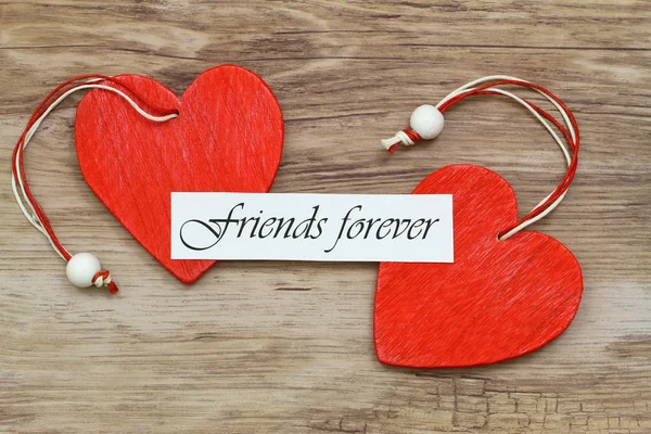 Friends forever card with two red wooden hearts — Stock Photo, Image