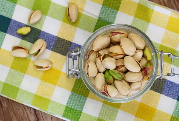 Pistachio nuts in vintage glass jar — Stock Photo, Image