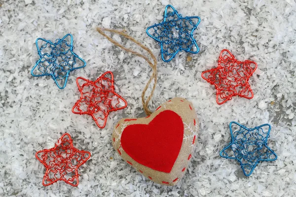 Canvas heart with colorful stars, on snowy surface — Stock Photo, Image