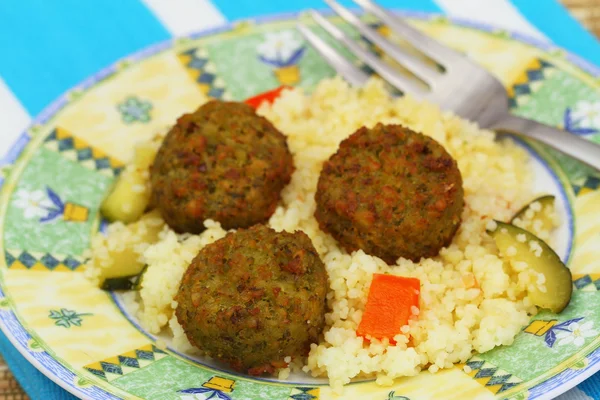 Falafel balls with couscous with fried vegetables, closeup — Stock Photo, Image