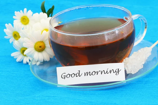 Good morning card with cup of tea and white daisies — Stock Photo, Image