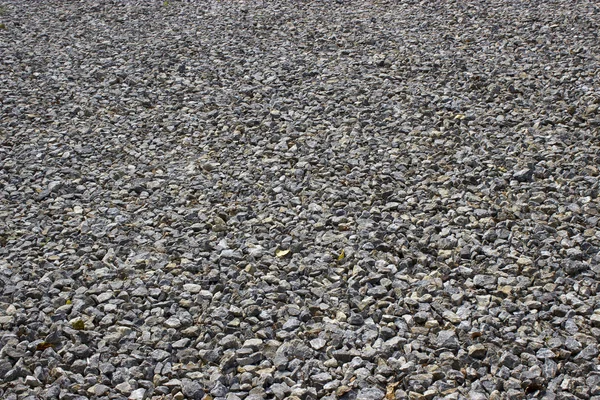 Kaba düzensiz gri taş eski serpilir çakıl arka plan