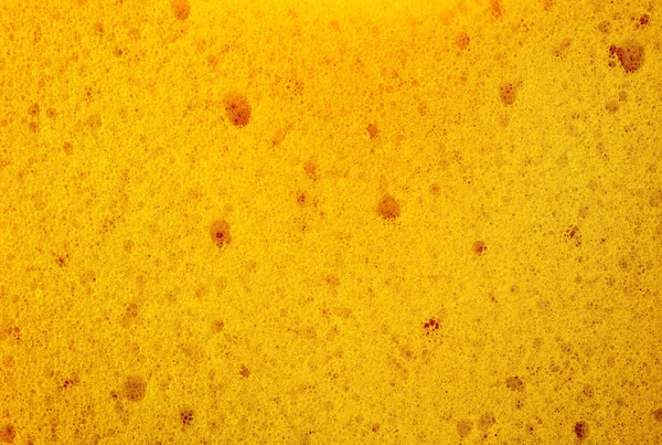 Abstract achtergrond gele poreuze zacht polyurethaanschuim — Stockfoto