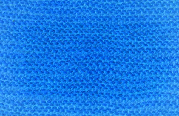 Blue background of knitted woolen braids knitting — Stock Photo, Image