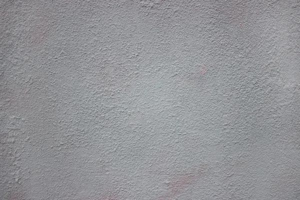 Грубый камень на фоне старой цементной стены с трещинами — стоковое фото
