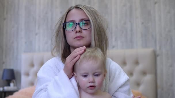 Disheveled mam kalmeert huilen baby in de ochtend — Stockvideo