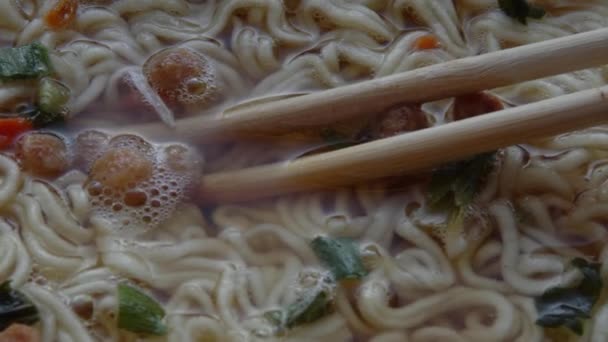 Close up of top ramen. Boiled instant noodle with Chinese chopsticks — Stock Video