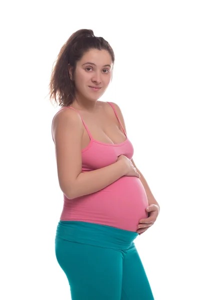 Young pregnant woman in bright sportswear hold her belly — Stock Photo, Image