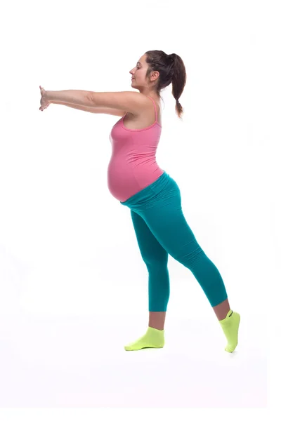 Young pregnant woman in bright sportswear doing yoga exersize — Stock Photo, Image