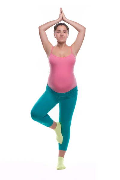 Young pregnant woman in bright sportswear doing yoga exersize — Stock Photo, Image