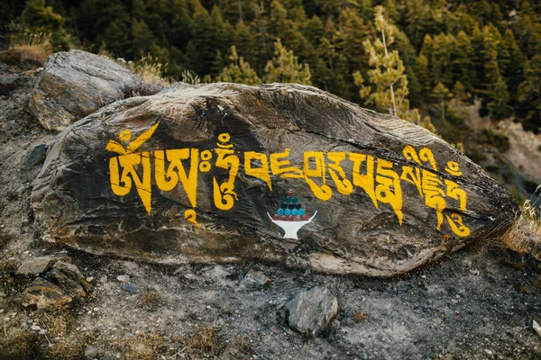 Mantra stone on the path in Himalayas. Trekking around Annapurna. — Stock Photo, Image