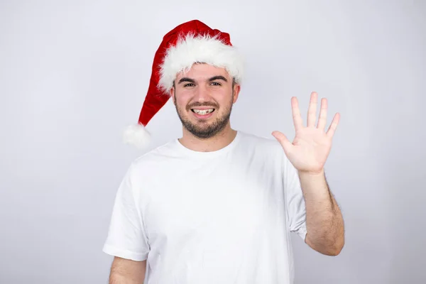 Joven Hombre Guapo Con Sombrero Santa Sobre Fondo Blanco Mostrando — Foto de Stock