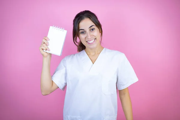Young Brunette Doctor Girl Wearing Nurse Surgeon Uniform Isolated Pink — Stock Photo, Image