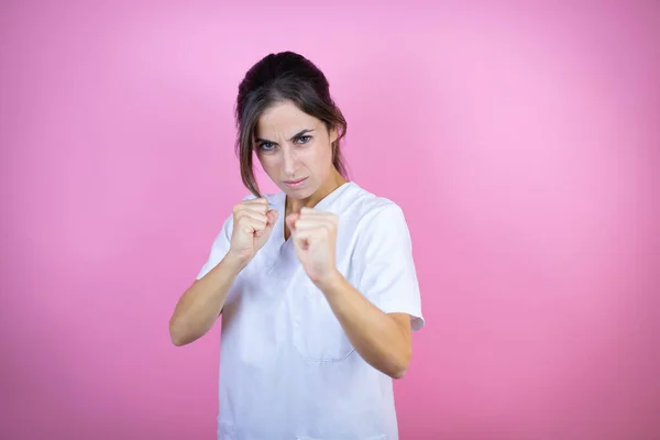 Young Brunette Doctor Girl Wearing Nurse Surgeon Uniform Isolated Pink — Stock Fotó