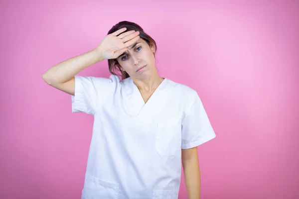 Young Brunette Doctor Girl Wearing Nurse Surgeon Uniform Isolated Pink — Stock Fotó