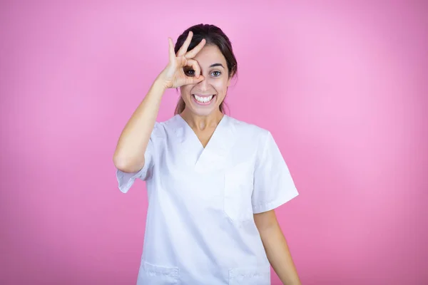 Young Brunette Doctor Girl Wearing Nurse Surgeon Uniform Isolated Pink — Stock Fotó