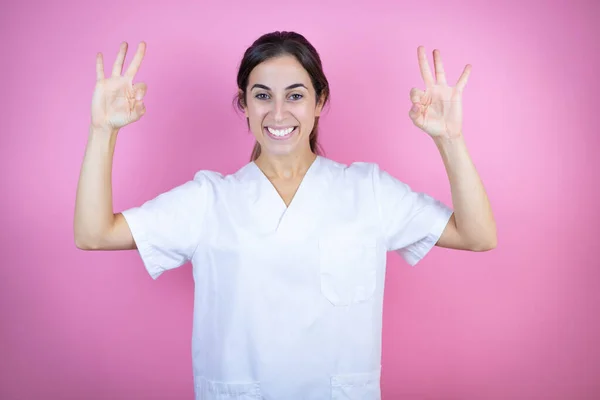 Young Brunette Doctor Girl Wearing Nurse Surgeon Uniform Isolated Pink — Stock Fotó