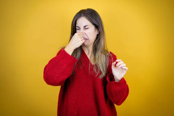 Young Beautiful Woman Wearing Red Sweater Isolated Yellow Background Smelling — Stock Photo, Image