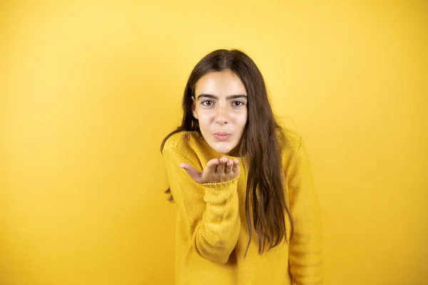 Pretty Girl Wearing Yellow Sweater Standing Isolated Yellow Background Looking — Zdjęcie stockowe