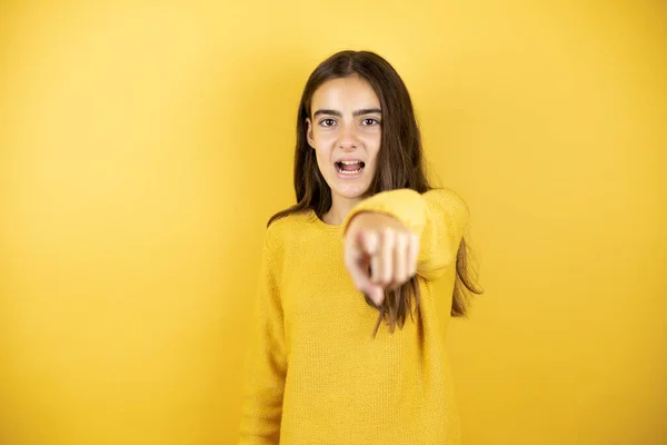 Pretty Girl Wearing Yellow Sweater Standing Isolated Yellow Background Pointing — Zdjęcie stockowe