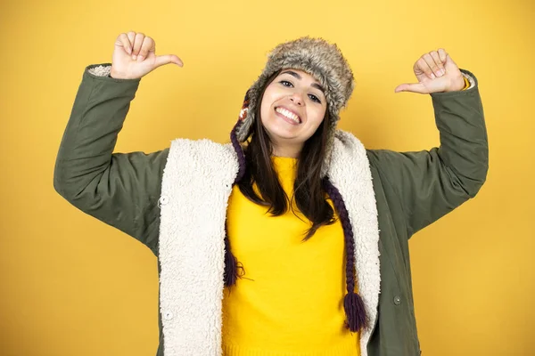 Young Beautiful Woman Wearing Hat Green Winter Coat Yellow Background — Stock Photo, Image