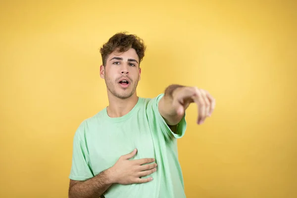 Hombre Guapo Con Una Camiseta Verde Casual Sobre Fondo Amarillo — Foto de Stock