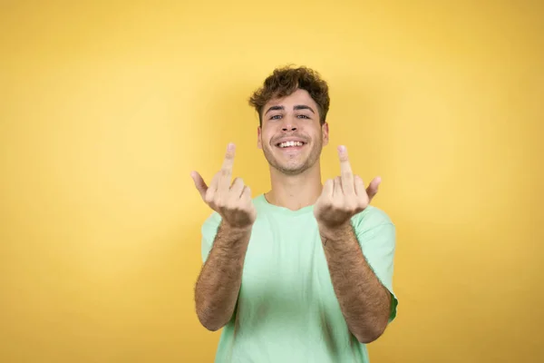 Handsome Man Wearing Green Casual Shirt Yellow Background Showing Middle — Foto de Stock