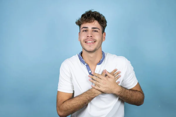 Junger Gutaussehender Mann Trägt Ein Weißes Shirt Über Blauem Hintergrund — Stockfoto