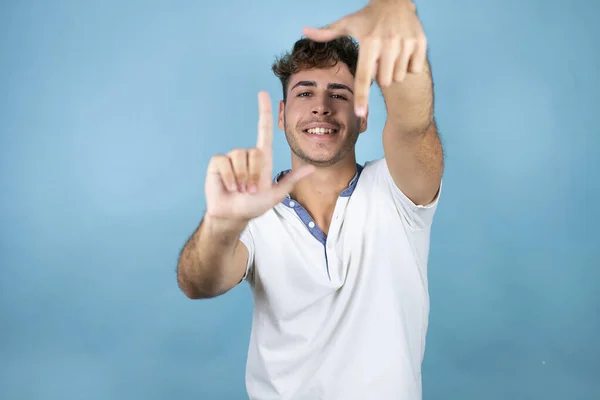 Ung Stilig Man Bär Vit Shirt Över Blå Bakgrund Leende — Stockfoto