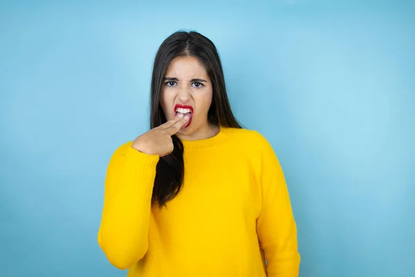 Young Beautiful Woman Wearing Yellow Sweater Isolated Blue Background Disgusted — ストック写真