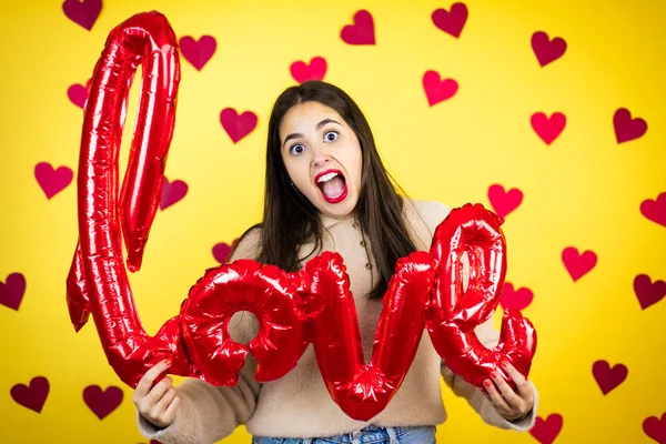 Young Caucasian Woman Yellow Background Red Hearts Holding Word Love — Stock Photo, Image
