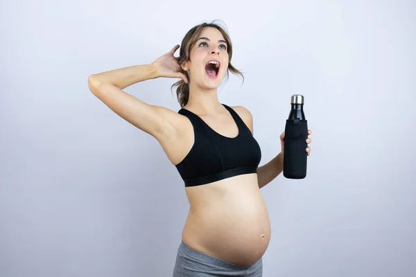 Young Sportswoman Pregnant Wearing Sportswear Holding Bottle Water White Background — Stock Photo, Image