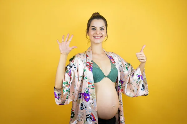 Young Beautiful Woman Pregnant Expecting Baby Wearing Pajama Isolated Yellow — Stock Photo, Image